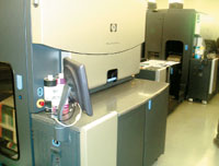 Между двумя печатающими механизмами HPIndigo W7200расположен модуль(справа) для регулировки натяжения полотна иинспекции результатов печати впервом механизме 