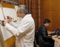 Небольшое представление было призвано показать, как далеко шагнули системы автоматизированного проектирования: за кульманом трудился инженер прежней поры, а рядом — современный, вооруженный планшетом iPad 